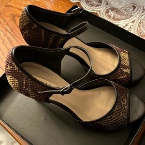 High heeled brown snake skin shoes